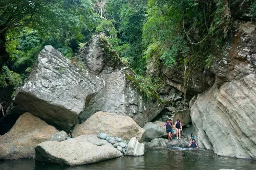 Kids river tracing through a dramatic boulder-lined gorge