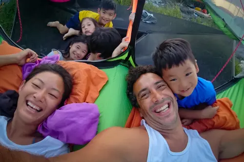 Camp leaders and kids packed into a tent for a fun group selfie