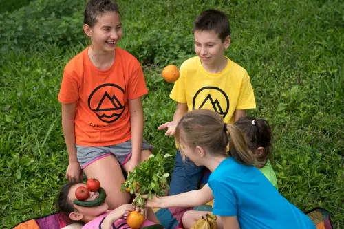 Kids in Camping Taiwan t-shirts sorting fresh vegetables they harvested