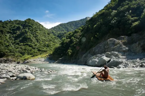 Headed home on a handmade bamboo raft.