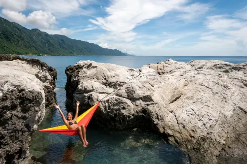 Relaxing above a natural tidal rock pool.